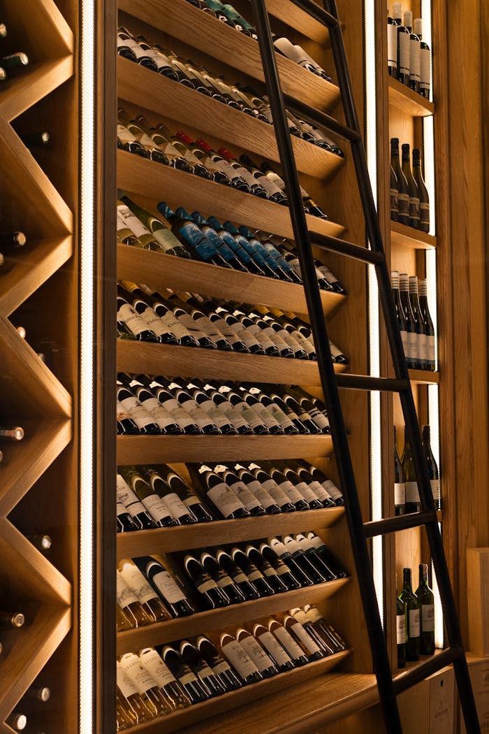 Accueil - Guide Cave à Vin Elegant wine cellar with diverse bottles on wooden shelves in Baku.